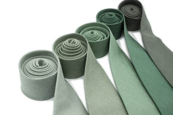 Collection of five linen neckties in shades of sage green including Dusty Sage, Bright Sage, Classic Sage, Dark Sage, and Eucalyptus, ideal for groomsmen at weddings.