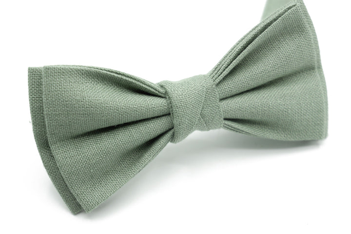 a green bow tie on a white background