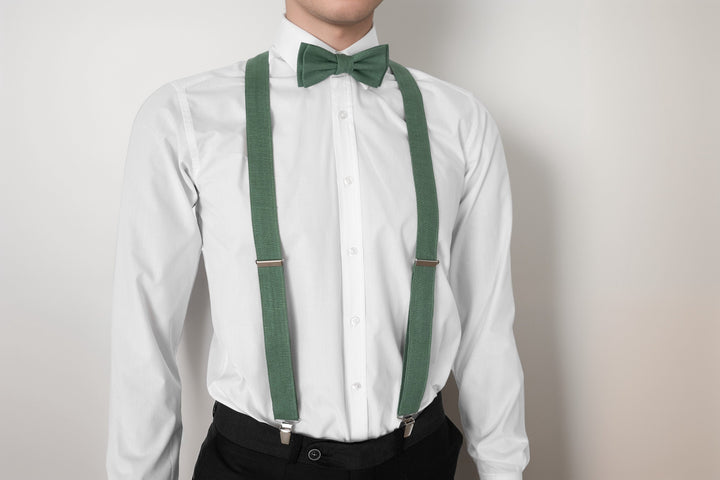 Man in white shirt showcasing adjustable sage green linen suspenders and matching bow tie, perfect for formal attire.