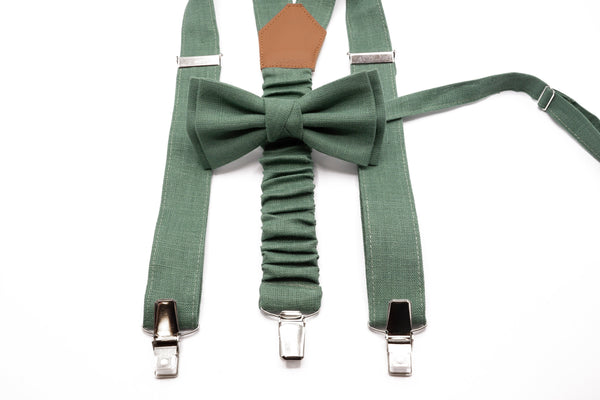 Sage green linen suspenders and bow tie set lying flat, showcasing adjustable clips and fine craftsmanship.