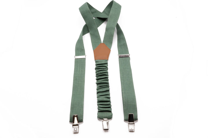 a pair of green suspenders with a brown button