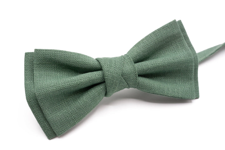 Detailed view of handmade sage green linen bow tie, emphasizing its fine weave and elegant design.