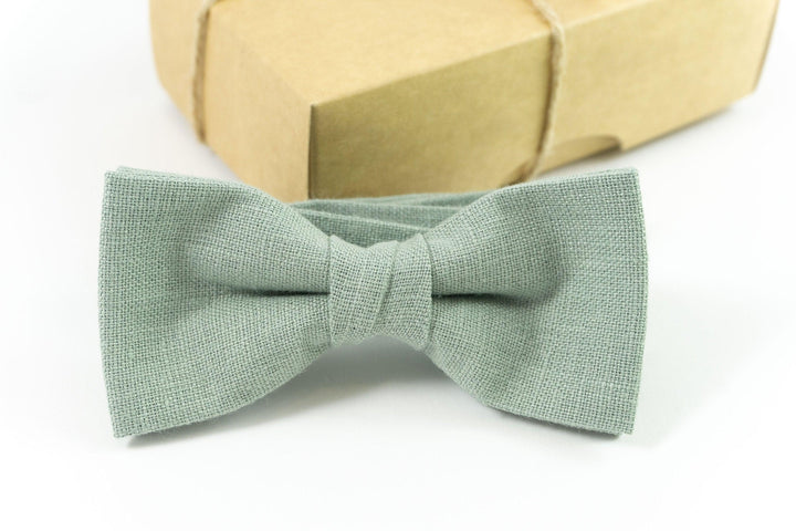 Dusty sage green adult bow tie attached to an adjustable strap